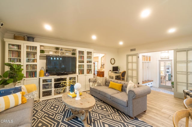 living room featuring french doors and light wood-type flooring