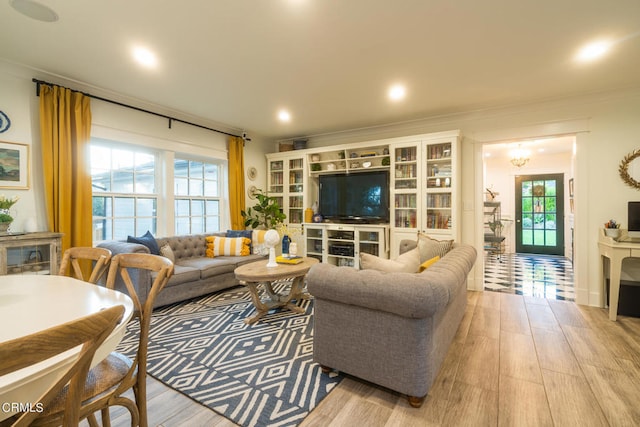 living room featuring light hardwood / wood-style flooring and ornamental molding