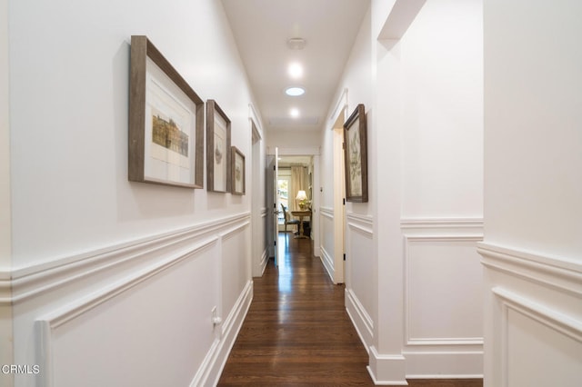 hallway with dark hardwood / wood-style flooring