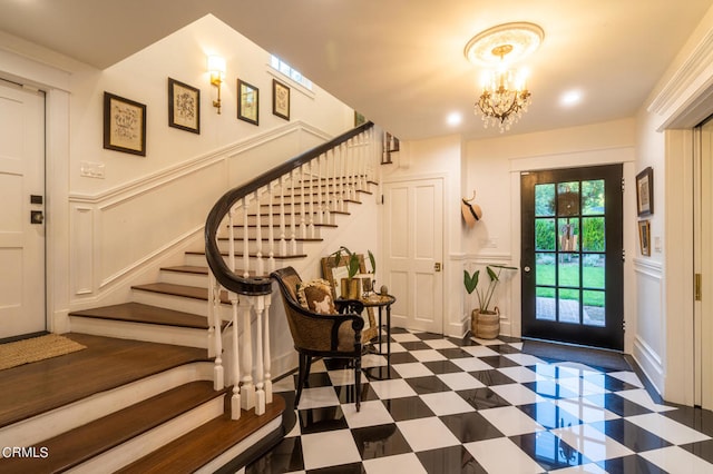 foyer entrance with a chandelier