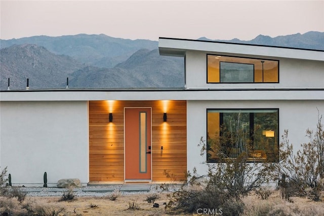 back house at dusk featuring a mountain view