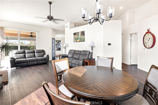 dining space with ceiling fan with notable chandelier and dark hardwood / wood-style floors