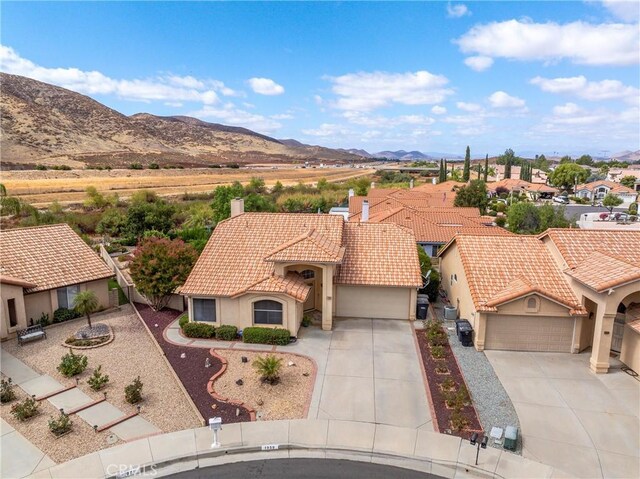 view of front facade with a mountain view and a garage