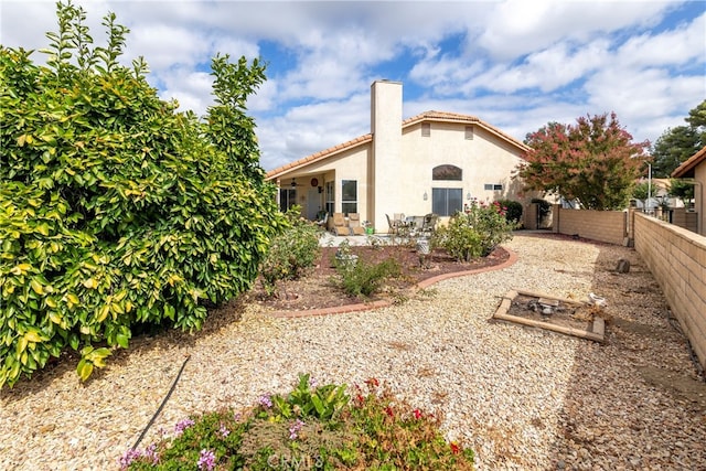 rear view of property featuring a patio area