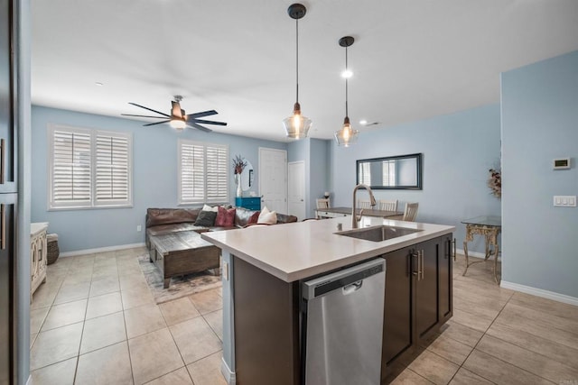 kitchen featuring sink, hanging light fixtures, a center island with sink, ceiling fan, and stainless steel dishwasher