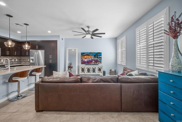 tiled living room featuring ceiling fan