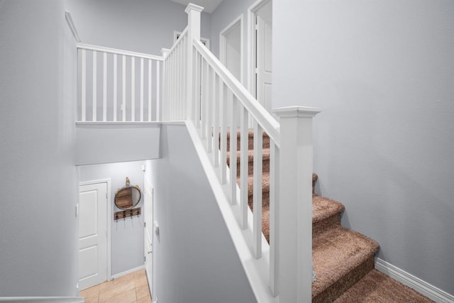 stairs featuring tile patterned flooring