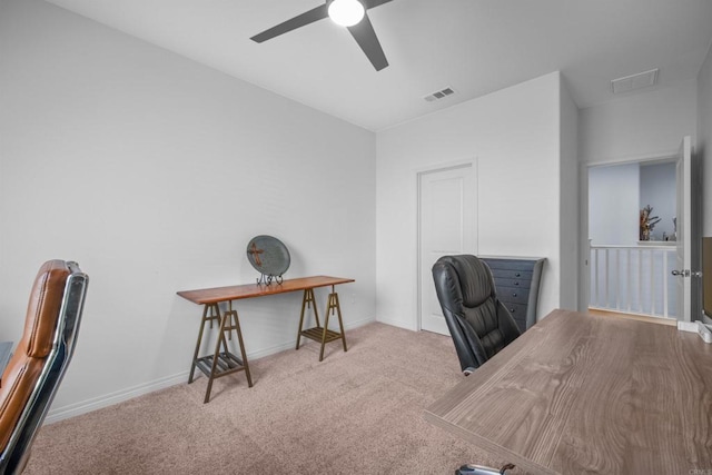 carpeted office space with ceiling fan