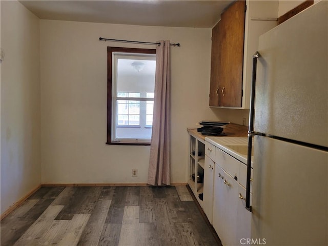 300 Bald Rock Rd, Berry Creek, CA 95916 - kitchen featuring freestanding refrigerator, wood finished floors, white cabinetry, light countertops, and baseboards