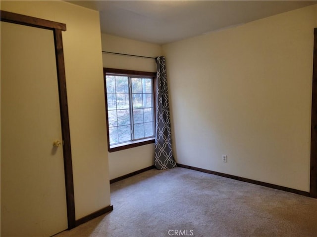 unfurnished bedroom with light colored carpet