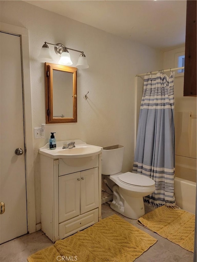 full bathroom featuring shower / bath combo, vanity, and toilet