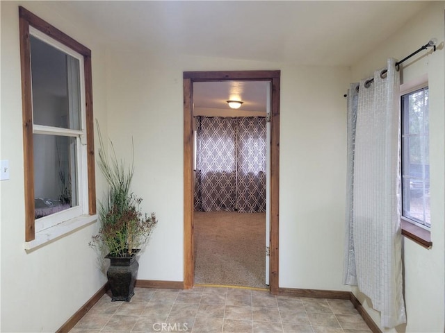 hall featuring light carpet