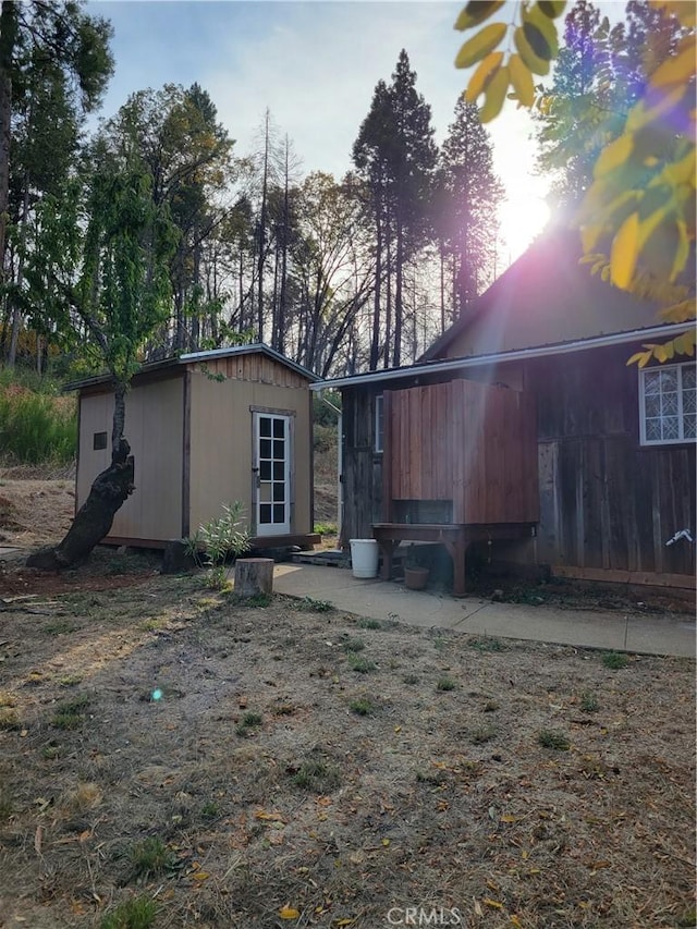 rear view of house with an outdoor structure