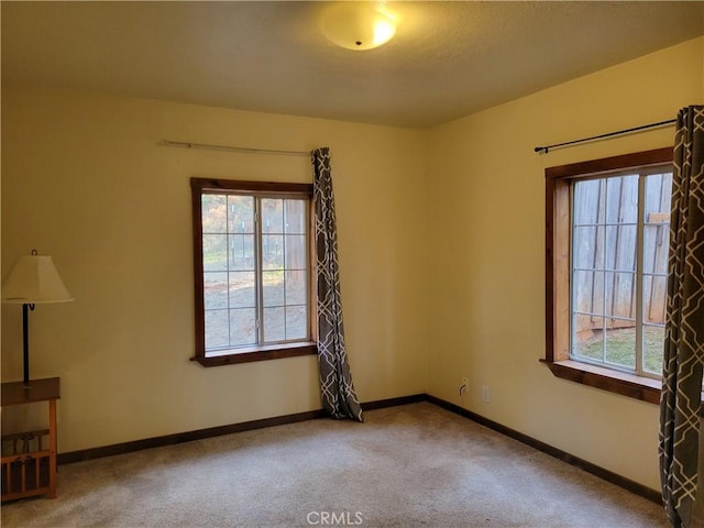 spare room with carpet flooring and a healthy amount of sunlight