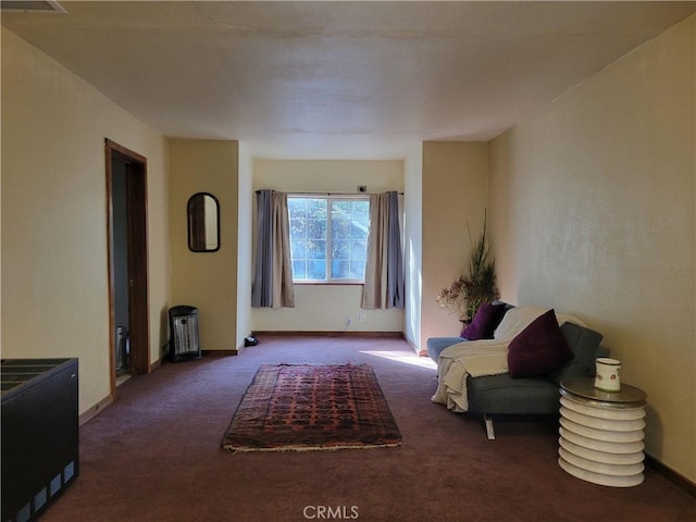 sitting room featuring dark carpet