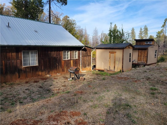 back of property with a storage unit