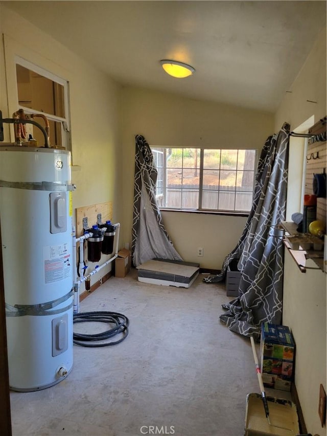 miscellaneous room featuring secured water heater and carpet floors