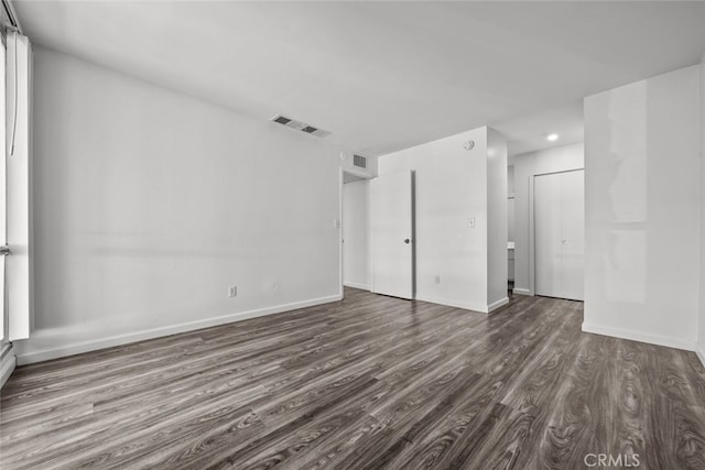 unfurnished bedroom featuring dark wood-type flooring