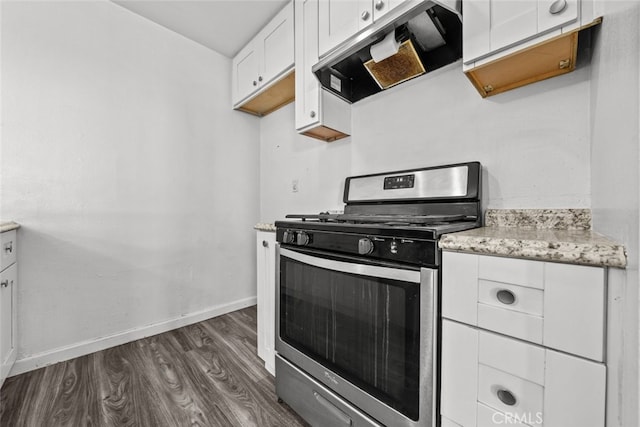 kitchen with dark hardwood / wood-style floors, stainless steel gas range, white cabinets, ventilation hood, and light stone counters