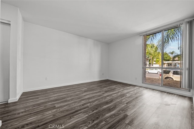 empty room with dark wood-type flooring