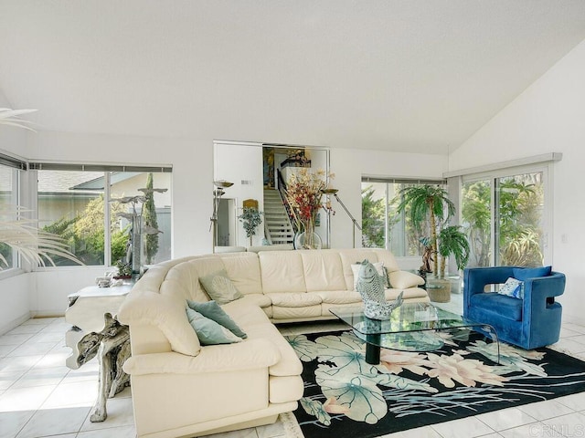 tiled living room featuring a wealth of natural light and vaulted ceiling