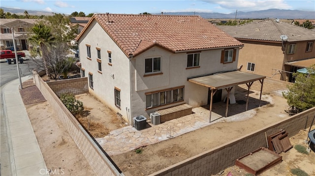 back of house featuring cooling unit and a mountain view