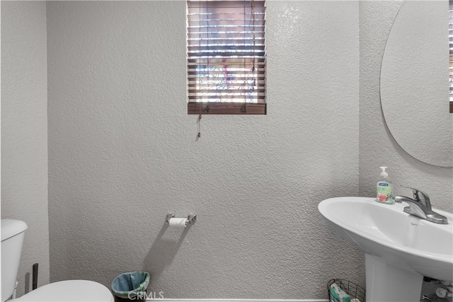 bathroom featuring sink and toilet