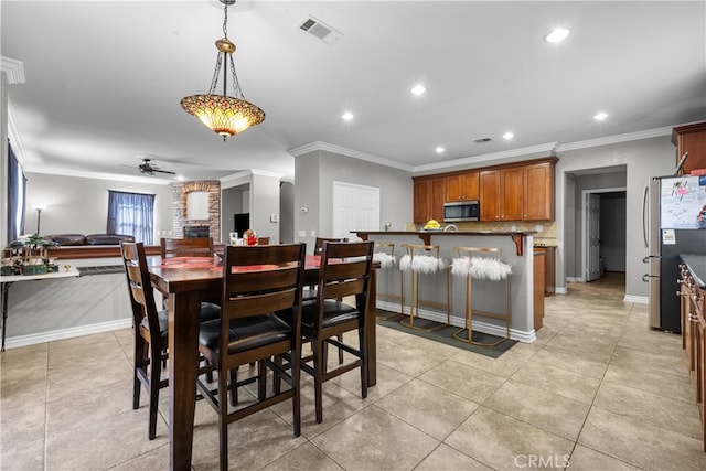 dining room featuring ceiling fan, light tile patterned floors, and ornamental molding