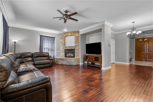 living room with crown molding, a fireplace, ceiling fan with notable chandelier, and dark hardwood / wood-style flooring