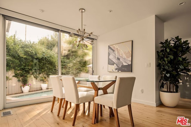 dining room featuring an inviting chandelier and light hardwood / wood-style floors