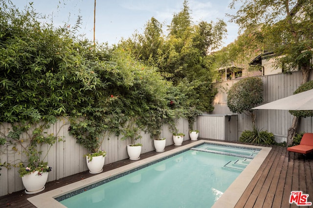 view of swimming pool featuring a wooden deck