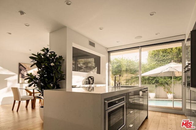 kitchen featuring light wood-type flooring and sink