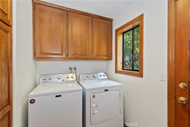 laundry room featuring cabinets and washer and dryer