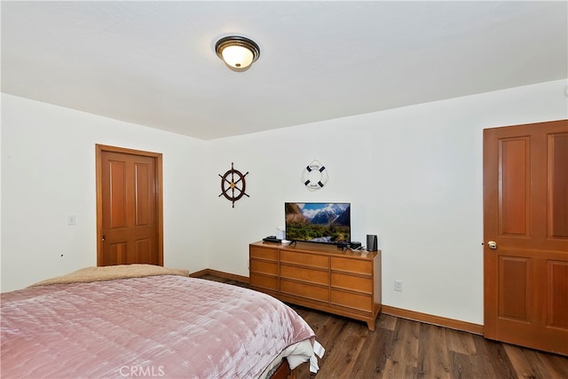 bedroom with dark hardwood / wood-style flooring