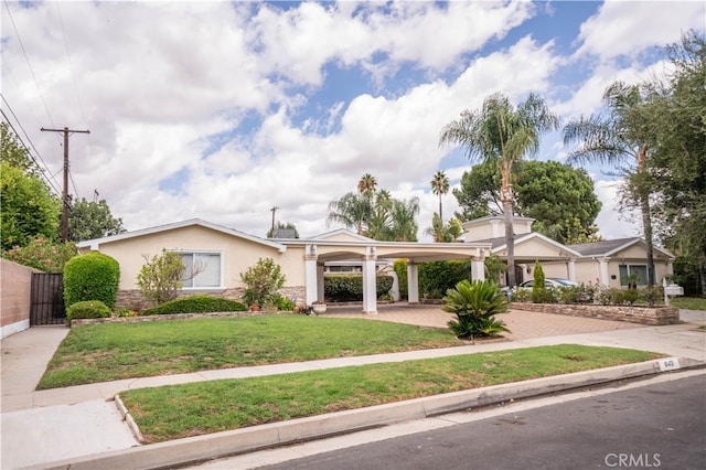 ranch-style house with a front yard and a carport