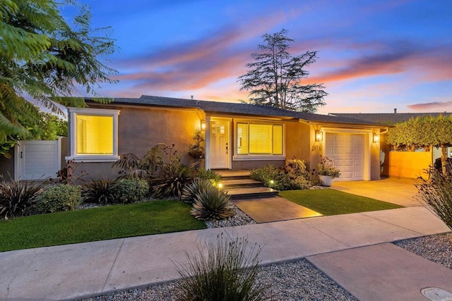 ranch-style home with a lawn and a garage