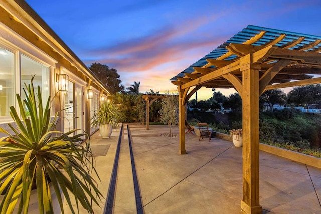 patio terrace at dusk with a pergola