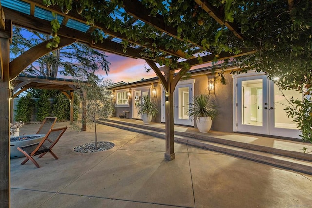 patio terrace at dusk featuring french doors