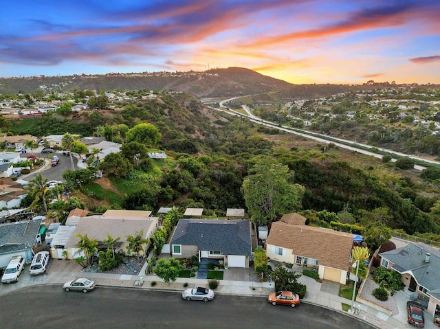 aerial view at dusk featuring a mountain view