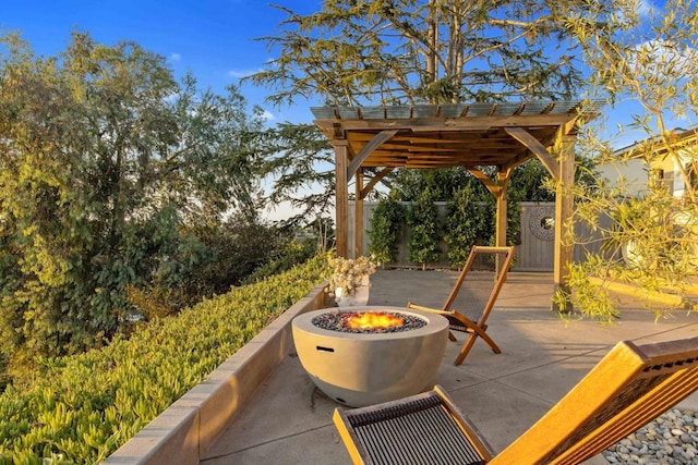 view of patio / terrace with a pergola and a fire pit