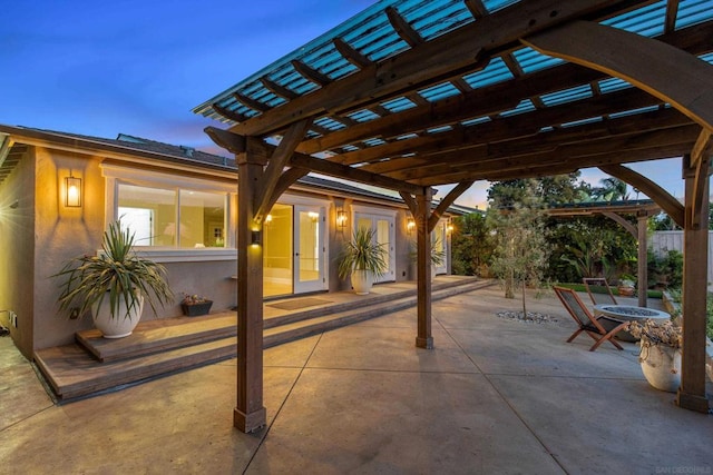 patio terrace at dusk featuring a pergola