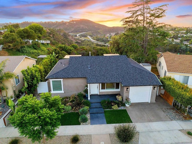 view of front of home with a mountain view and a garage