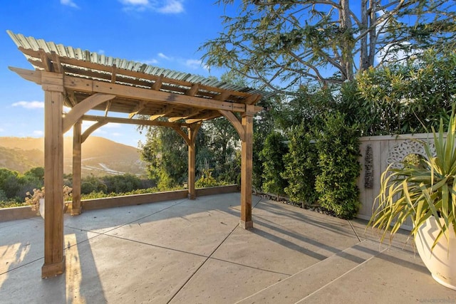 view of patio / terrace featuring a pergola and a mountain view