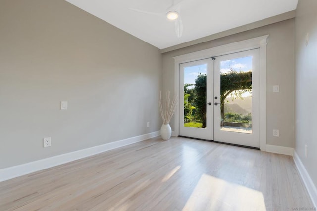 empty room featuring light hardwood / wood-style flooring, a wealth of natural light, ceiling fan, and french doors