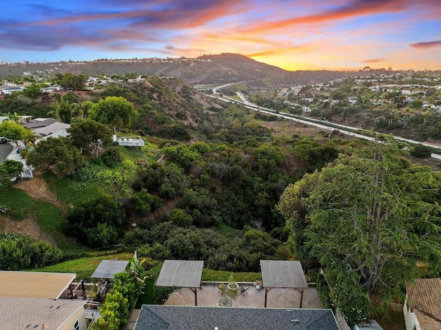 aerial view at dusk featuring a mountain view