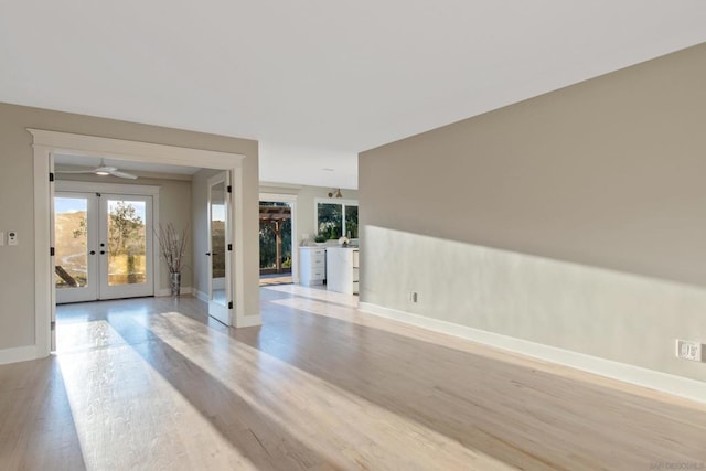 spare room featuring french doors, light hardwood / wood-style flooring, and ceiling fan