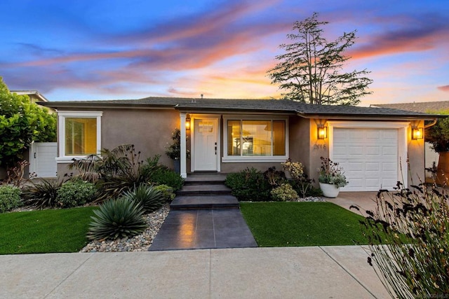 view of front of property featuring a yard and a garage