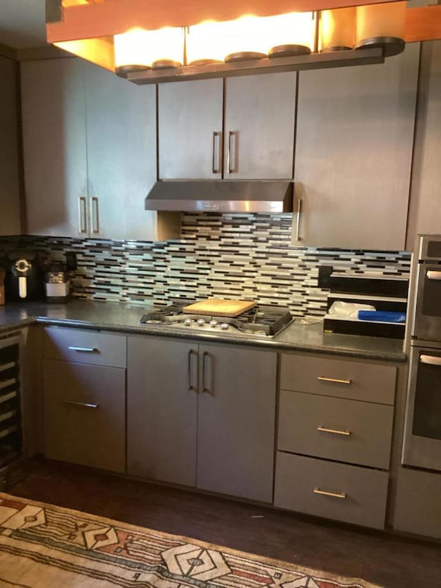 kitchen featuring gray cabinetry, decorative backsplash, and stainless steel gas cooktop