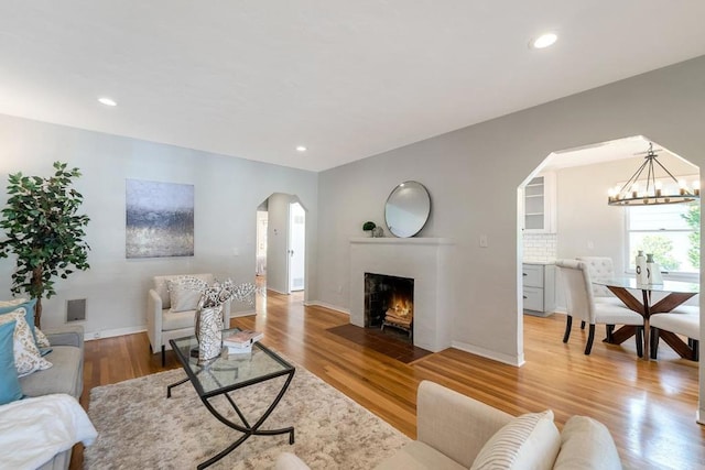 living room with an inviting chandelier and hardwood / wood-style floors