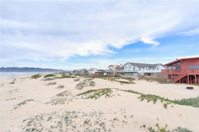 exterior space with a water view and a view of the beach